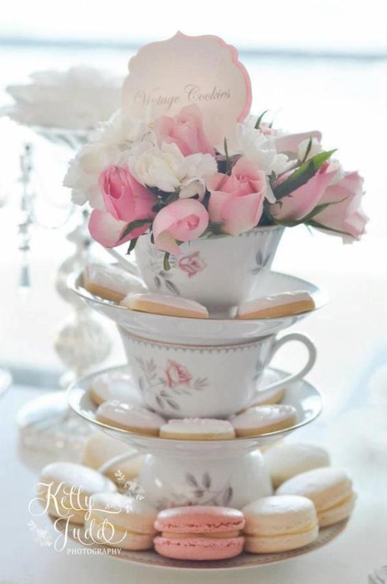 Tower of Teacups and saucers with cookies on them and roses on top - 14 Bridgerton hen party ideas - party decor  - Teacups